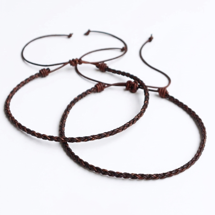 Two adjustable couple braided necklaces in dark brown, arranged overlapping on a clean white background.