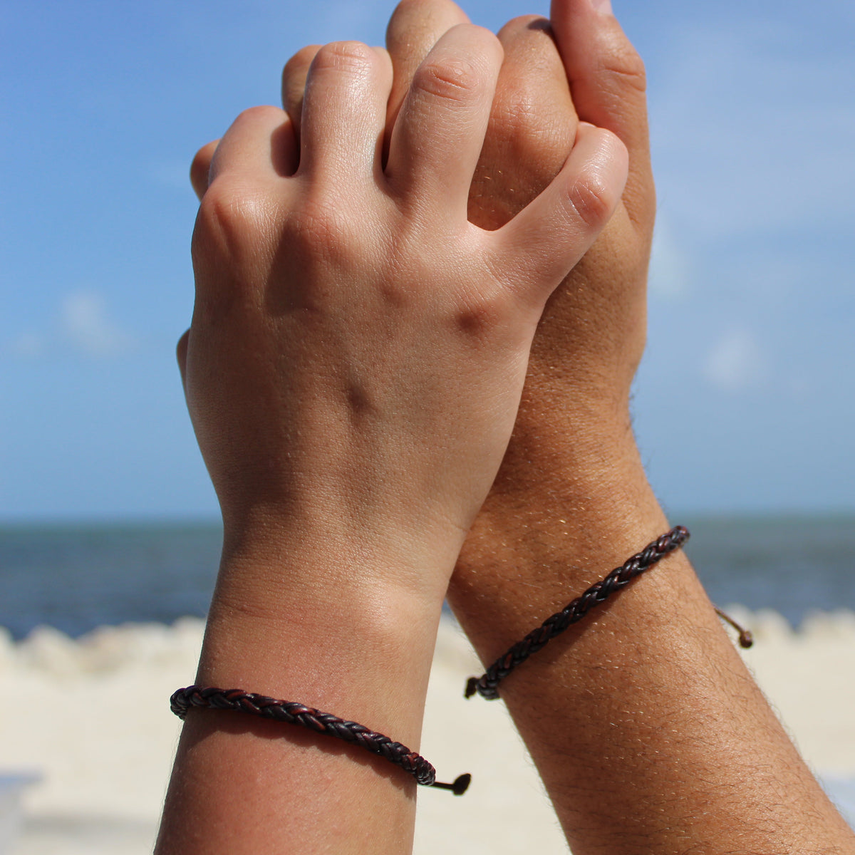 Bolo leather couple bracelets dark brown adjustable sliding knot closeup
