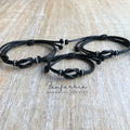 Three infinity black cord family bracelets with silver accents and a knot design.