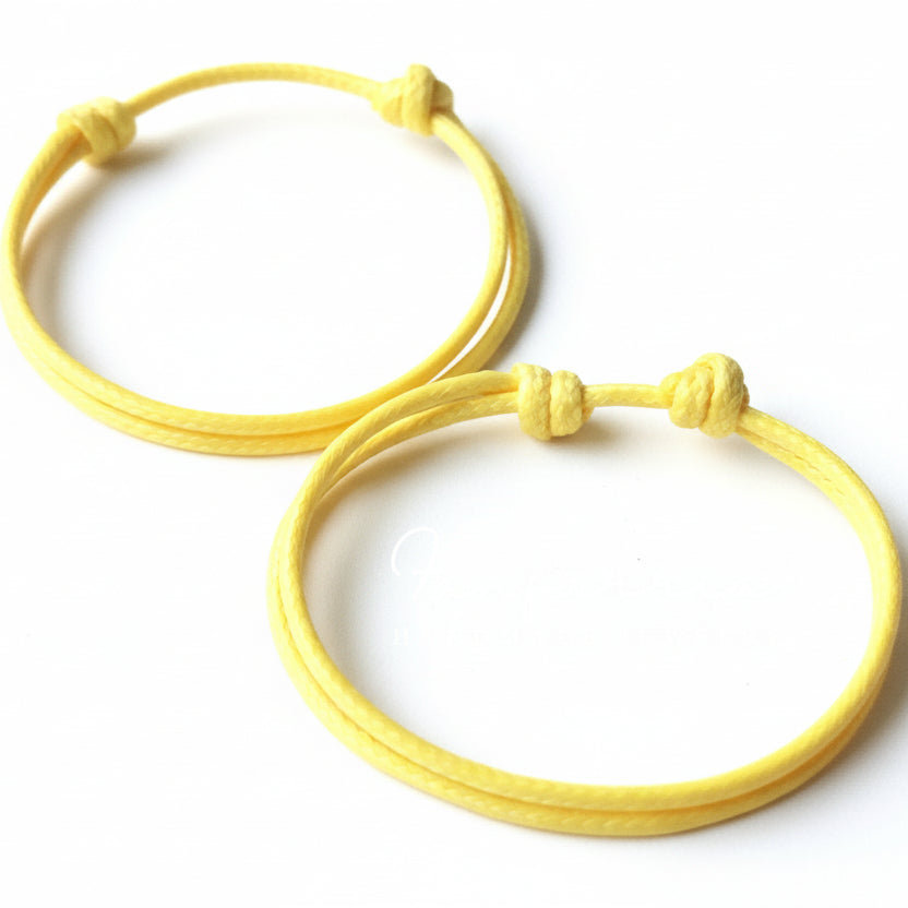 Orange macrame couple bracelets flat lay adjustable waterproof minimalist