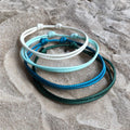 White, Sky Blue, Turquoise, Deep Teal. Collins 2mm Minimalist bracelets in shades of green, blue, and white.