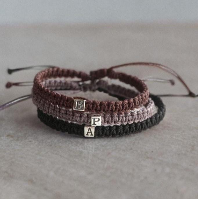 Handmade personalized initial bracelet with sterling silver cube letter on adjustable cord, minimalist boho style, waterproof and unisex design by Fanfarria.