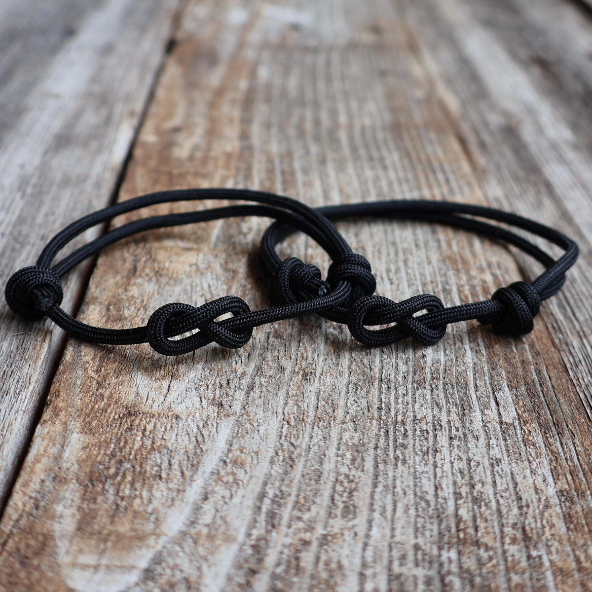 Matching couples bracelet set in black 3mm nylon with infinity knot