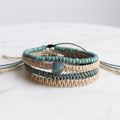 Stacked beach-inspired bracelet set showing teal, tan, and turquoise braided designs