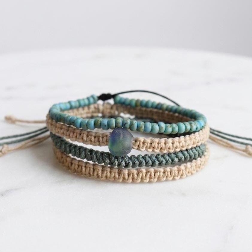 Stacked beach-inspired bracelet set showing teal, tan, and turquoise braided designs