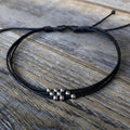 Minimalist black adjustable cord anklet bracelet with silver beads, handmade waterproof beach jewelry for women and men, stackable boho surfer ankle bracelet