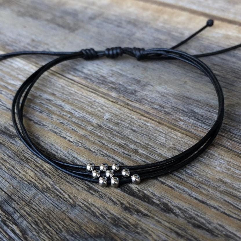 Minimalist black adjustable cord anklet bracelet with silver beads, handmade waterproof beach jewelry for women and men, stackable boho surfer ankle bracelet