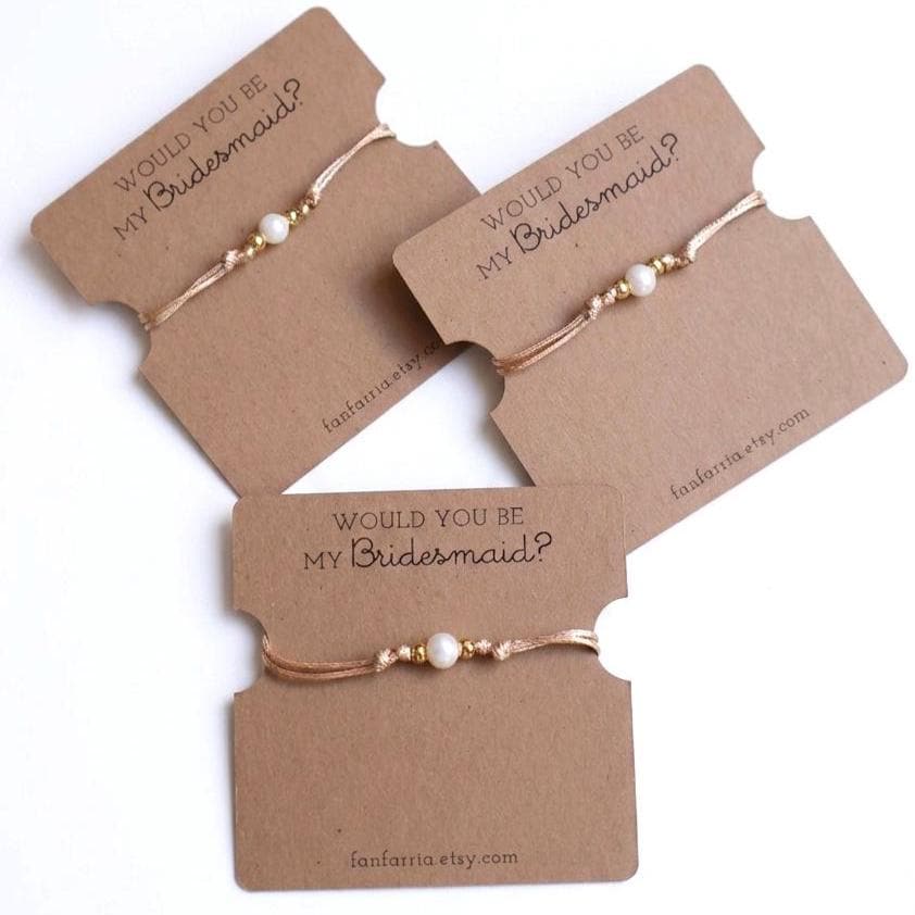 Would You Be My Bridesmaid freshwater pearl bracelets with gold plated beads on kraft cards, set of three displayed on white background