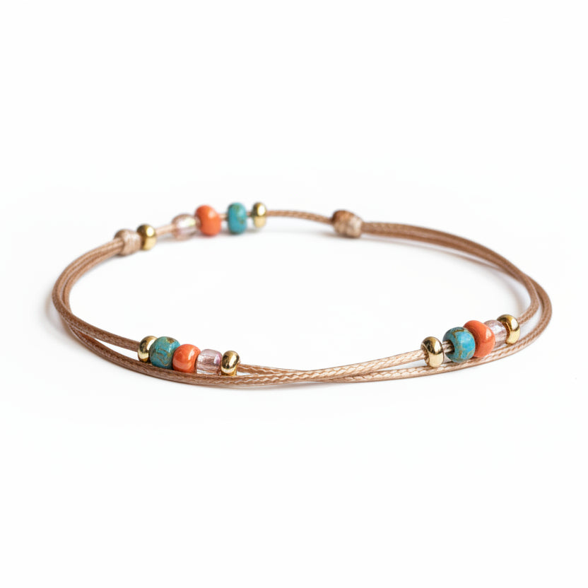 Boho beaded cord bracelet and anklet with turquoise, coral, and gold-tone accent beads on adjustable waxed cord