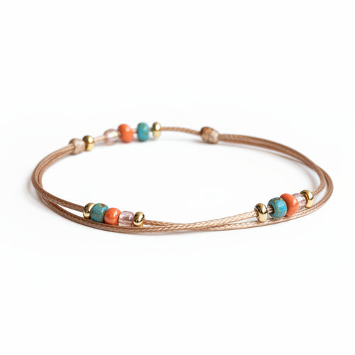 Boho beaded cord bracelet and anklet with turquoise, coral, and gold-tone accent beads on adjustable waxed cord