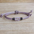 Lavender leather Celtic knot bracelet with black and silver accents, featuring a double-wrap design and adjustable closure. Handmade boho leather bracelet for women, perfect for everyday wear or a meaningful gift.