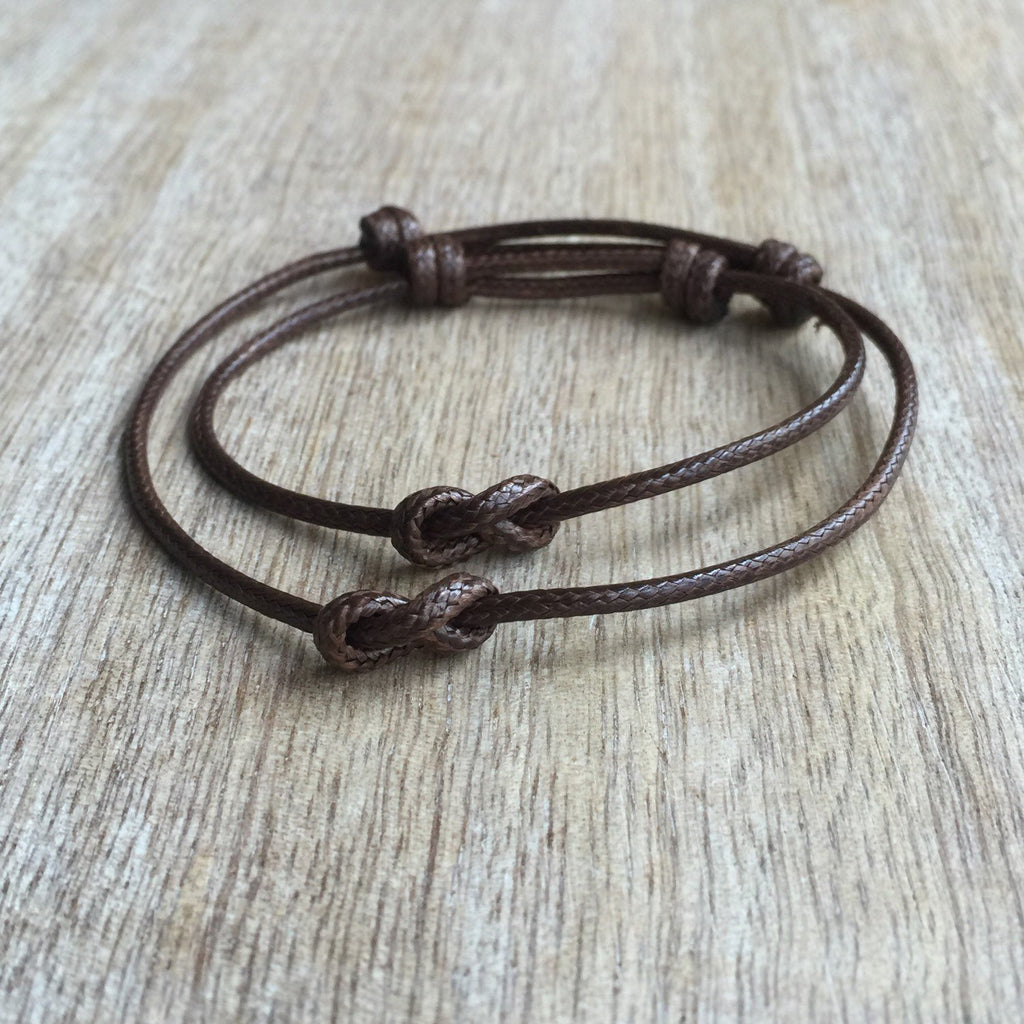 Brown infinity knot his and hers couple bracelets on wrist lifestyle photo