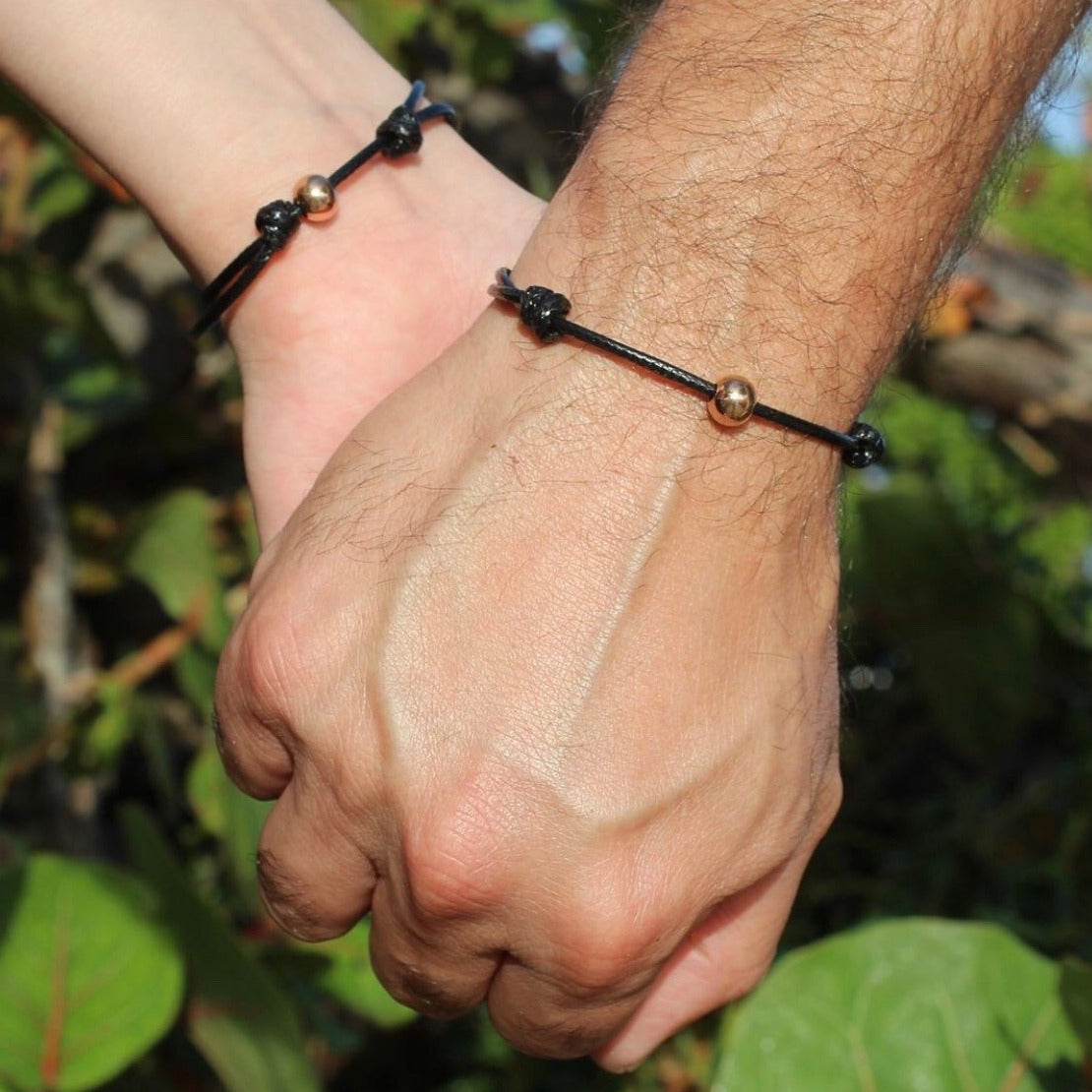 His and hers rose gold stainless steel couple bracelets flat lay closeup