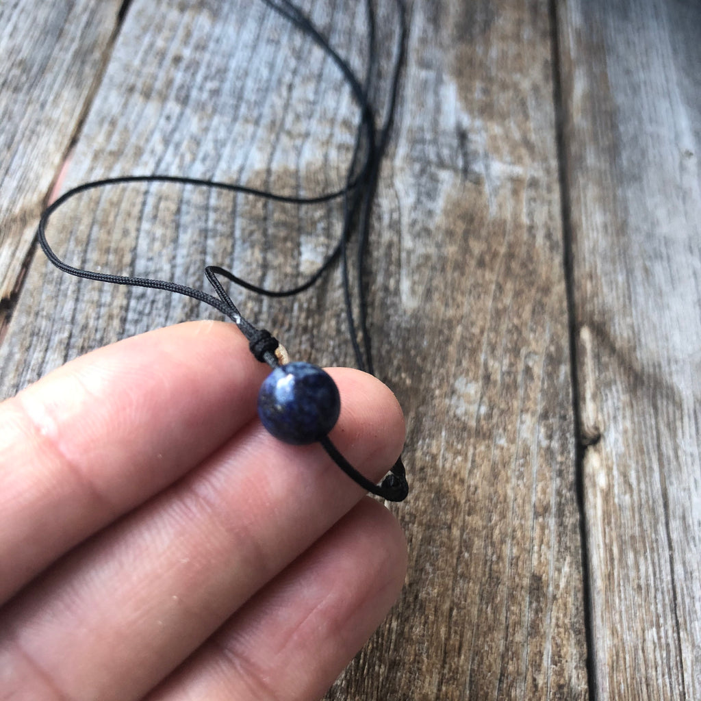 Lapis lazuli blue bead black cord choker necklace flat lay adjustable
