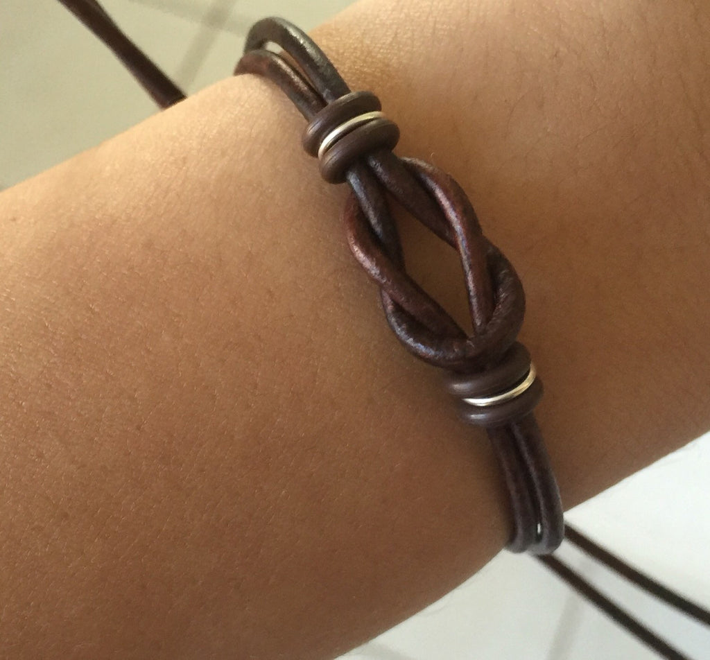 Dark brown leather his and hers matching bracelets on wrist lifestyle photo