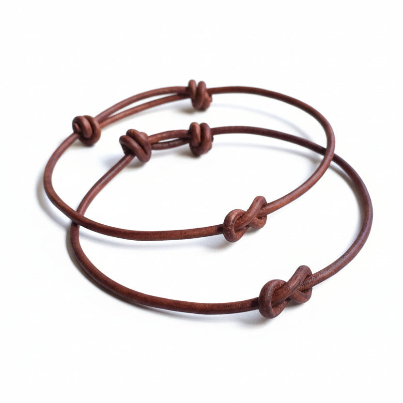 Leather infinity knot couple bracelets brown adjustable on wrist lifestyle